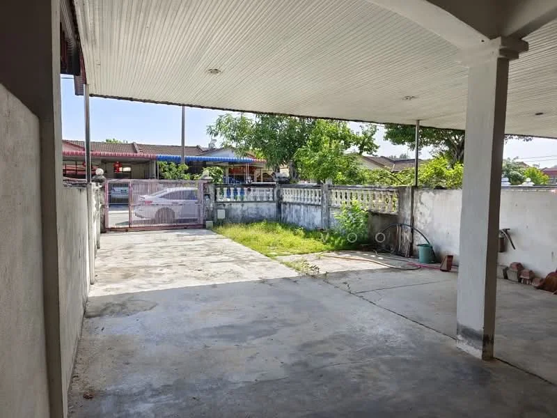 Exterior features: concrete flooring, covered car porch, fenced perimeter, manicured lawn, garden area, exposed concrete walls, metal gate, surrounded by greenery; style: modern.