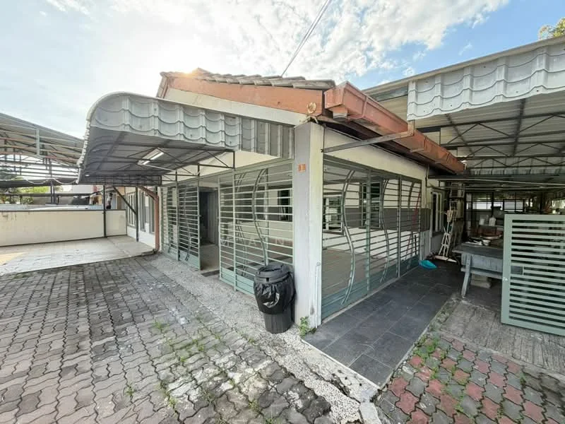 Exterior type: linked terrace house; features: metal roof with overhang, grilled windows, paved driveway, exposed brick wall, white painted facade, outdoor space with patio, garbage bin, surrounding greenery; style: modern.