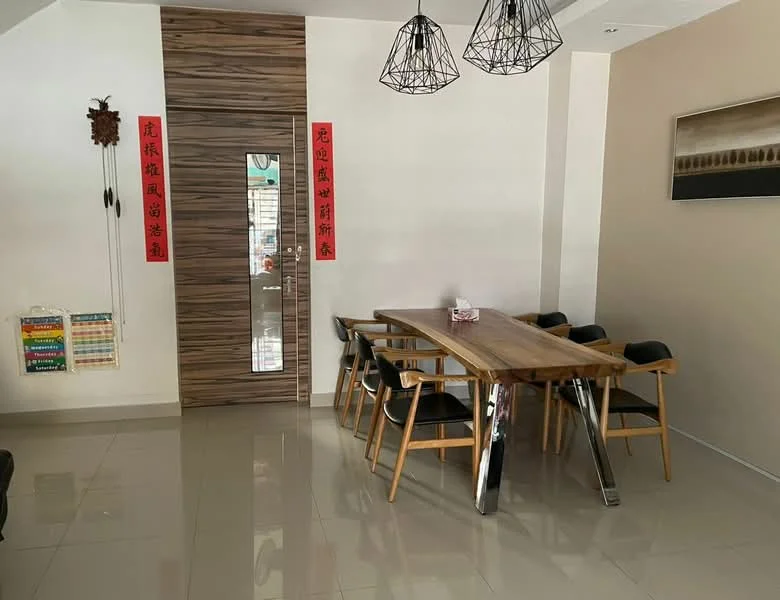 Dining features: wooden dining table, 6-seater dining table, black upholstered dining chairs, pendant lighting fixtures, cream painted walls, glossy tile flooring, decorative wall art, wooden door with vertical slats, Chinese calligraphy wall hangings; style: modern.