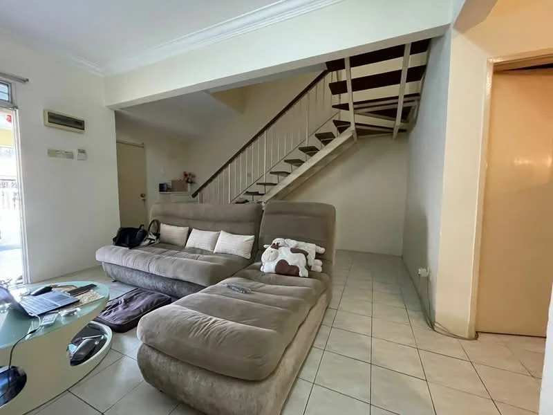 Living features: L-shape sectional sofa in beige, glass coffee table, tile flooring, white painted walls, staircase with wooden railing, wall-mounted air conditioning unit, doorway leading to another room, natural light from window; style: modern.