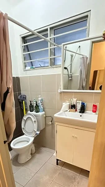 Bathroom features: white ceramic toilet, single-sink vanity with white cabinet, mirror above vanity, shower with handheld showerhead, grey wall tiles, light beige floor tiles, window with horizontal bars, toiletries on vanity, towel rack, curtain rod, shower curtain; style: modern.
