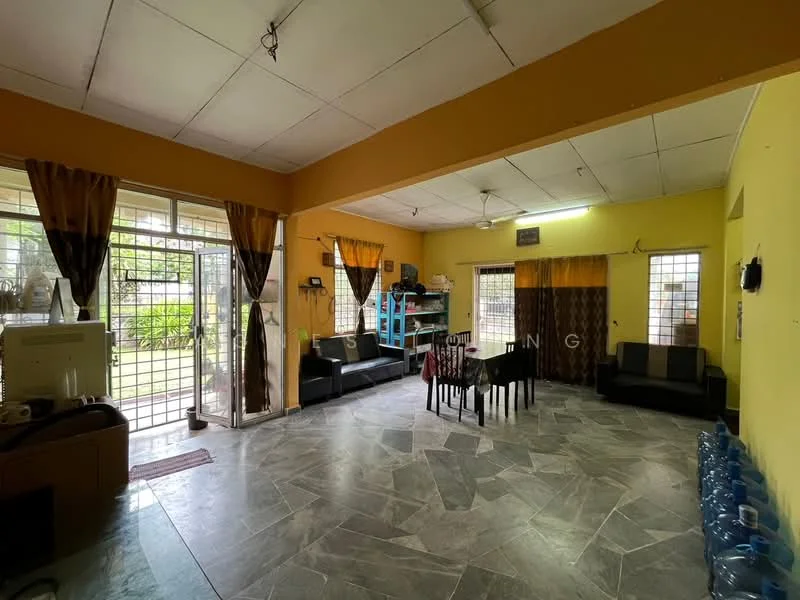 Living features: grey marble tile flooring, yellow painted walls, white ceiling, 2 black leather sofas, coffee table, large windows with black curtains, glass sliding door, decorative wall shelves, water dispenser, potted plants visible outside; style: contemporary; view: garden.