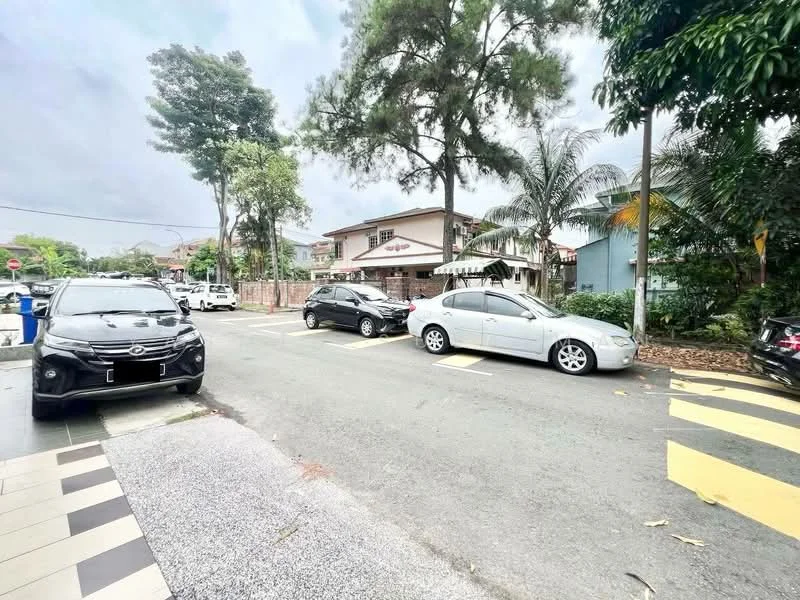 Exterior type: detached bungalow; features: two-storey building, white painted facade, surrounded by greenery, paved driveway, street view, parking spaces, mature trees, residential area; style: modern.