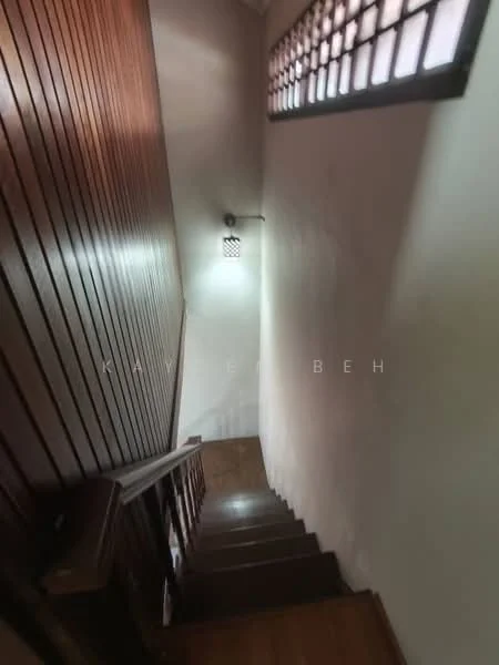 Room features: wooden staircase, wood paneling on walls, light fixture on wall, window with grid pattern, laminate flooring, neutral wall color; style: traditional.