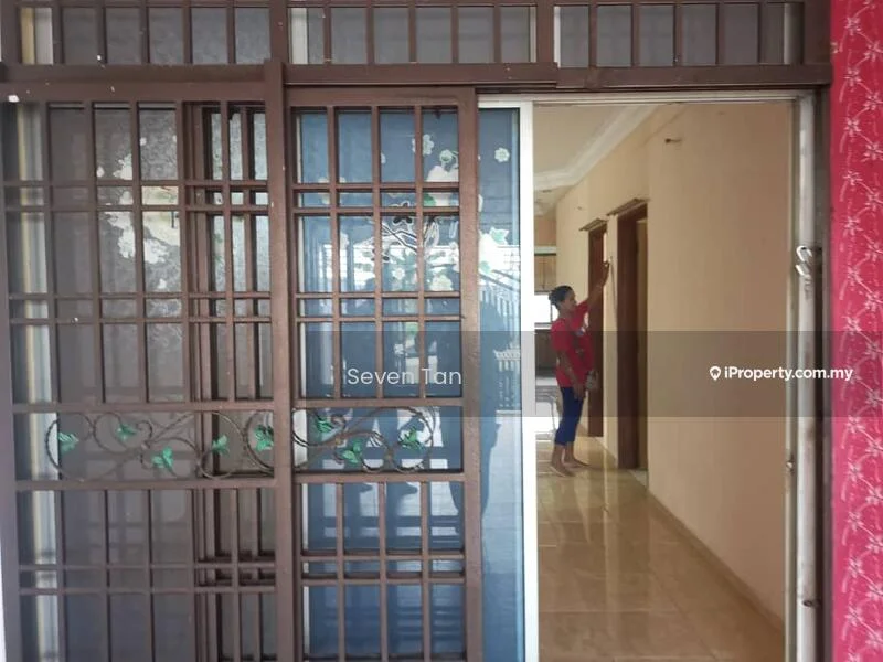 Room features: sliding glass door, wooden grille door, cream painted walls, tile flooring, decorative wall paneling, door frames, light ceiling, visible person in the background.