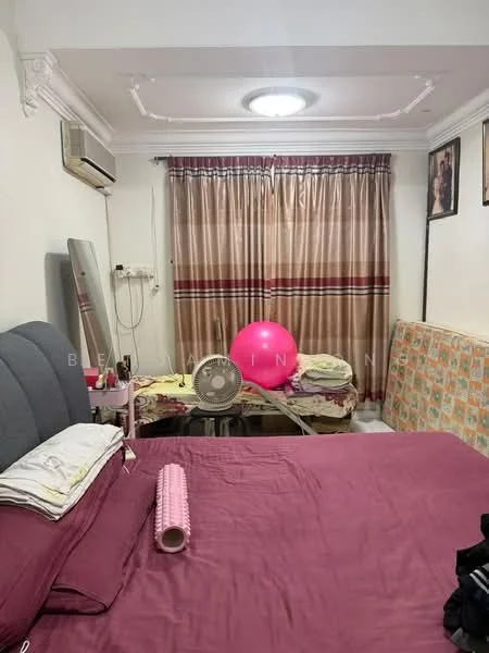 Bedroom features: king-size bed with grey upholstered headboard, purple bedspread, wall-mounted air conditioning unit, ceiling light fixture, floor-to-ceiling curtains with a striped pattern, large mirror, wooden table with various items, exercise ball, fan on the table, decorative wall art, sofa with patterned upholstery.