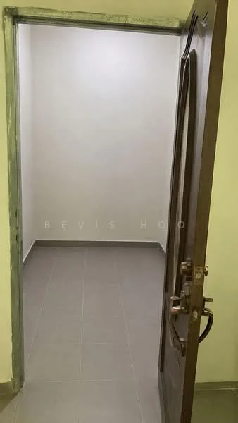 Room features: white painted walls, grey tile flooring, wooden door, door handle, light fixture on ceiling.