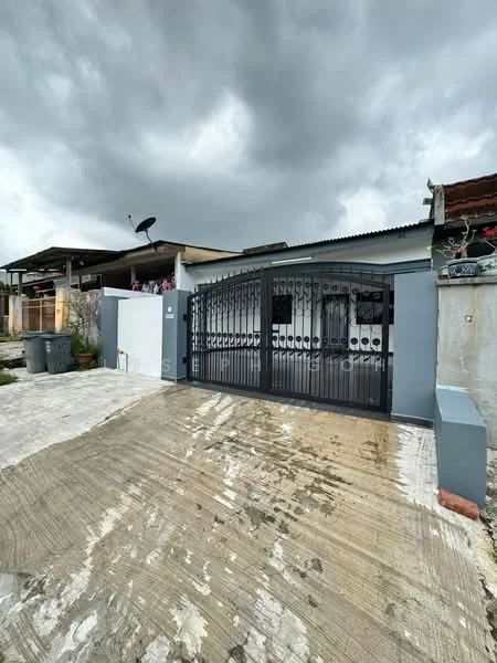 Exterior type: detached bungalow; features: metal gate, concrete driveway, grey painted facade, roof with overhang, satellite dish on roof, surrounding greenery, exposed brick wall, paved walkway; style: modern.