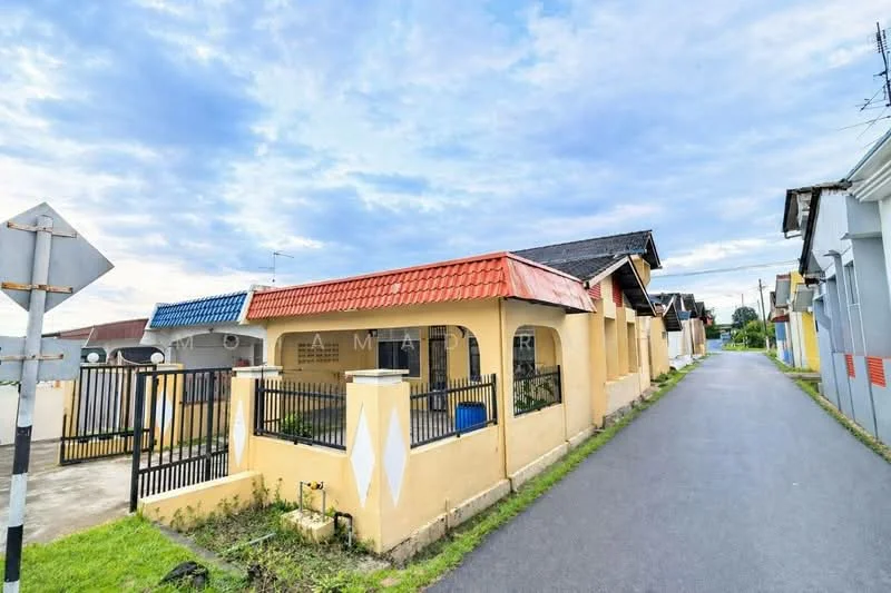 Exterior type: linked terrace house; features: yellow painted facade, red tiled roof, black wrought iron gate, manicured lawn, paved walkway, single-storey, surrounded by residential street, front porch area; style: modern.