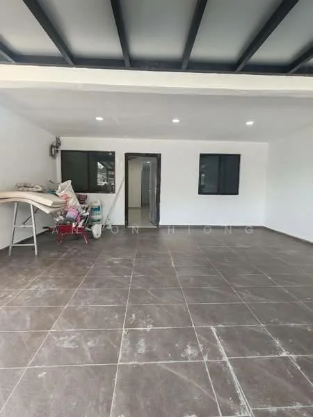 Room features: white painted walls, grey tiled flooring, exposed ceiling beams, recessed LED downlights, two windows, open layout, doorway leading to another room, furniture and materials stacked in the corner; style: modern.