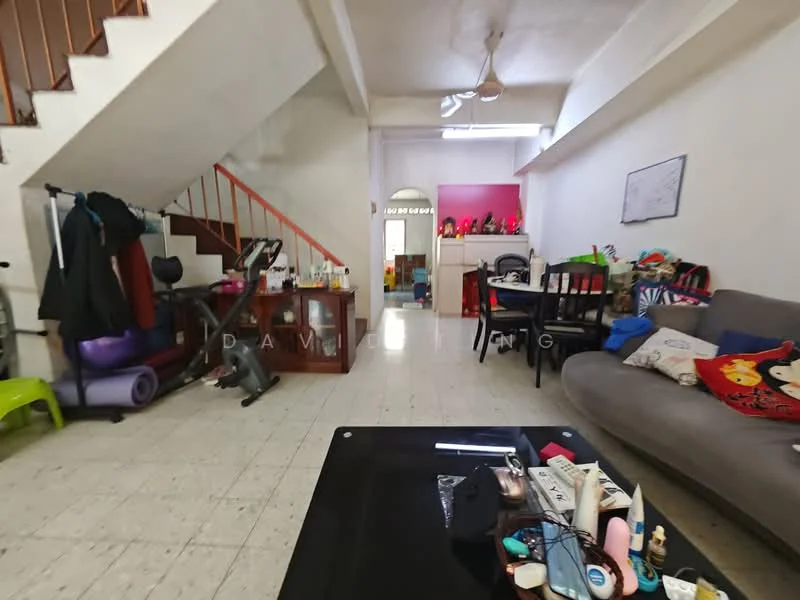 Living features: grey fabric sofa, black coffee table, wooden dining table with chairs, exercise equipment, ceiling fan, white walls, tile flooring, decorative cushions, various decorative items on table. Room features: staircase, open space, exercise bike, colorful decor items.