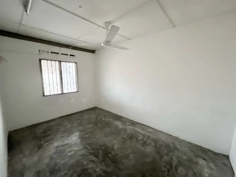 Room features: white painted walls, concrete flooring, ceiling fan, window with metal grille.