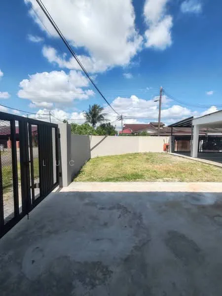 Exterior features: manicured lawn, concrete driveway, fenced perimeter, clear blue sky, overhead power lines, surrounding residential buildings; style: modern.