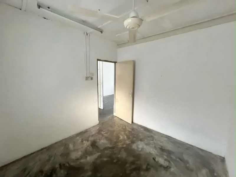 Room features: white painted walls, concrete flooring, ceiling fan, single door, light switch, exposed electrical wiring.
