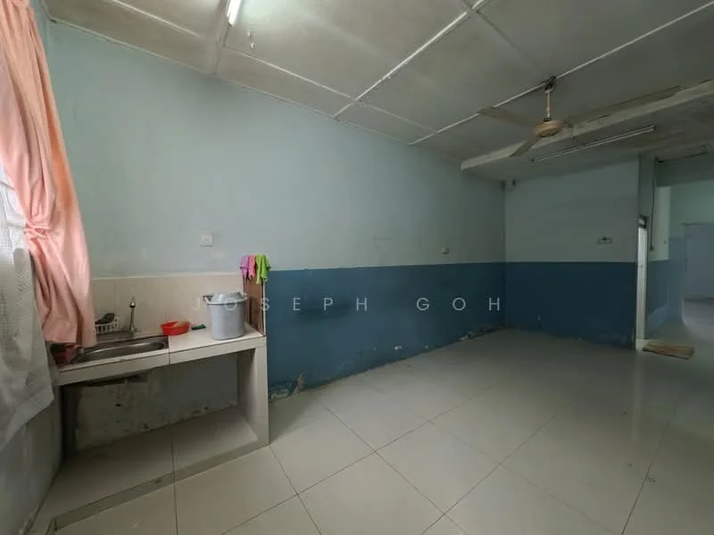 Kitchen features: single-bowl stainless-steel sink, chrome faucet, white tiled backsplash, light grey painted walls, blue painted accent wall, white ceramic tile flooring, ceiling fan, window with sheer curtains, countertop space, hanging cloths on hooks.