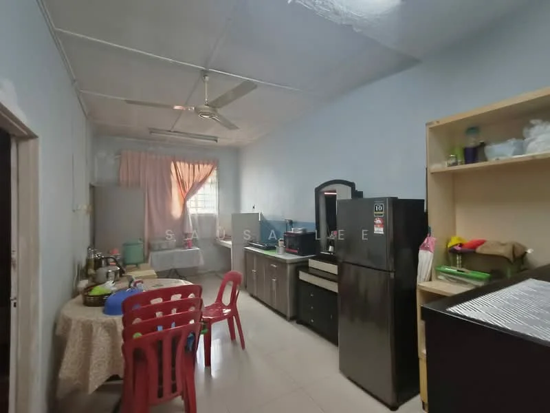 Kitchen features: white painted walls, tile flooring, ceiling fan, single-bowl stainless-steel sink, black refrigerator, built-in kitchen cabinets, countertop with storage, dining table with tablecloth, red plastic chairs, window with sheer curtains.