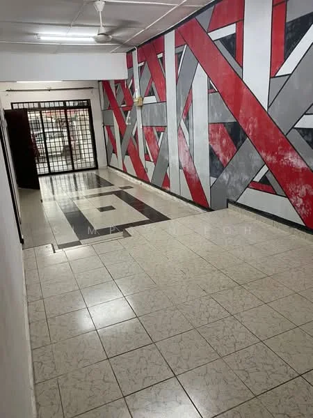 Room features: grey accent wall, red geometric pattern wall, white walls, marble tile flooring, ceiling fan, metal security grille door, open layout, natural light from entrance; style: modern.