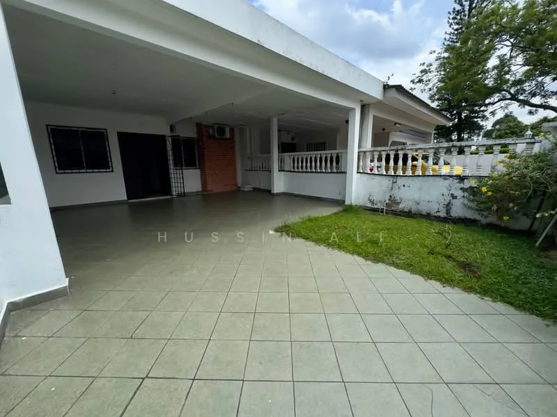 Exterior type: detached bungalow; features: covered porch, tiled flooring, manicured lawn, white painted facade, exposed brick wall, air conditioning unit visible, fenced perimeter, garden area with shrubs; style: modern.