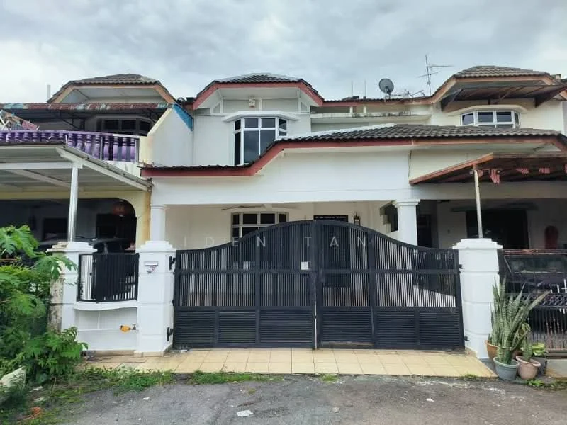 Exterior type: linked terrace house; features: white painted facade, red tiled roof, black metal gate, paved driveway, front porch with tiled flooring, two-storey structure, balcony on upper floor, visible air conditioning units, surrounded by greenery; style: modern.