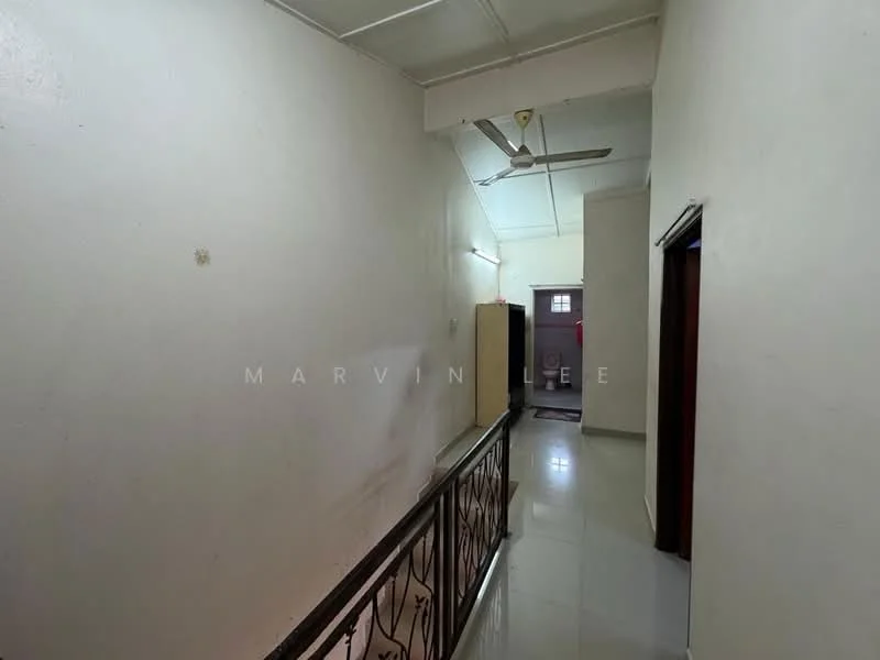 Hallway features: white painted walls, glossy tile flooring, ceiling fan, doorway leading to another room, railing along the side, natural light from windows, plain ceiling, neutral color scheme.