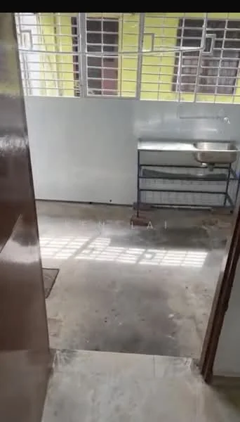 Room features: concrete flooring, white painted walls, metal sink, metal shelving unit, window with metal grilles, natural light from window.