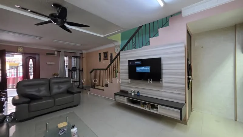 Living features: grey leather sofa, glass coffee table, wall-mounted TV, TV console with storage, ceiling fan, light pink painted walls, green accent wall, tile flooring, staircase with black railing, decorative wall clock; style: modern.