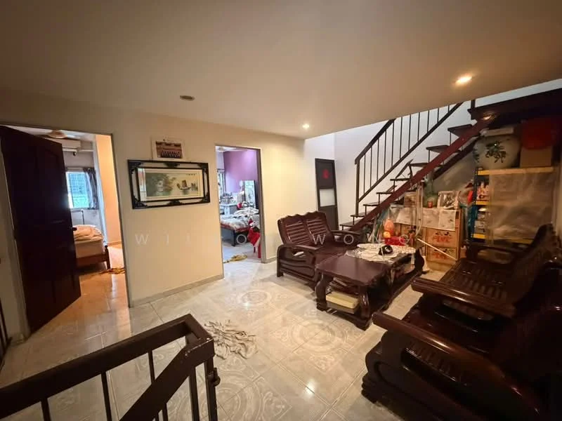 Living features: wooden furniture, brown wooden coffee table, brown wooden armchairs, tiled flooring, recessed ceiling lights, staircase with wooden railing, decorative wall art, open layout to adjacent rooms; style: traditional. Room features: visible doorway to adjacent room, light-colored walls, carpeted floor in adjacent room.