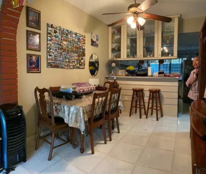 Dining features: dining table with tablecloth, wooden dining chairs, ceiling fan with light, white tiled flooring, brick archway, wall-mounted photo collage, mirror on wall, bar counter with stools, kitchen cabinetry in background, visible kitchen appliances, decorative items on table; style: traditional.