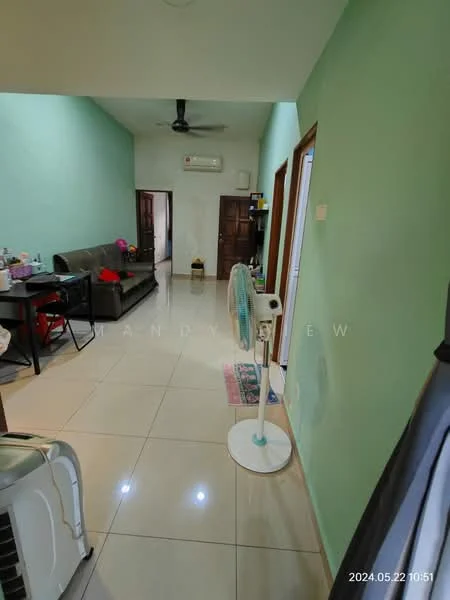 Room features: light green painted walls, white ceiling, ceramic tile flooring, 3-blade ceiling fan, wall-mounted air conditioning unit, brown leather sofa, dining table with chairs, standing fan, doorway leading to another room, decorative rug, small shelving unit, various items on table; style: modern.