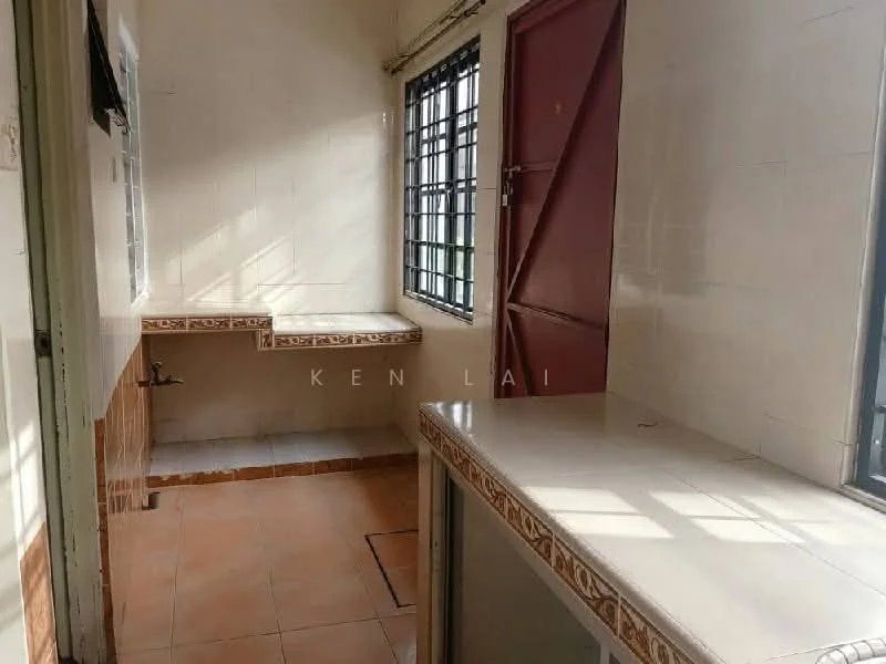 Room features: white tiled walls, cream tiled flooring, two built-in countertops, window with metal grilles, red door, natural light from windows.