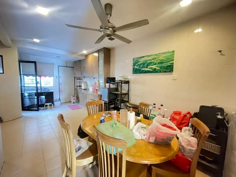 Dining features: round wooden dining table, 4 wooden dining chairs, ceiling fan with light, tile flooring, white painted walls, kitchen area visible in background, black shelving unit, various bottles and containers on table, decorative wall art, kitchen appliances visible in background; style: modern.