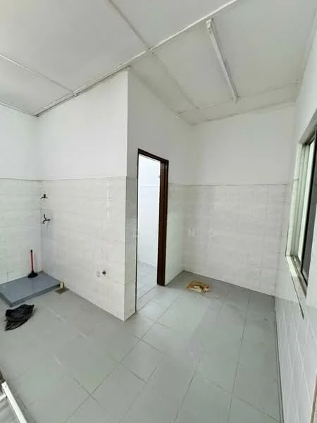 Room features: white painted walls, grey tiled flooring, exposed ceiling, two wall-mounted shower fixtures, window with natural light, doorway leading to another space, empty space, no visible fixtures or furniture; style: minimalist.
