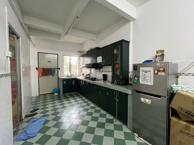 Kitchen features: green cabinetry, white countertop, stainless-steel fridge, built-in oven, 4-burner gas hob, sink, window with natural light, checkered tile flooring in green and white, exposed beams on ceiling, wall-mounted kitchen utensils, kitchen appliances, open shelving, boxes in corner.
