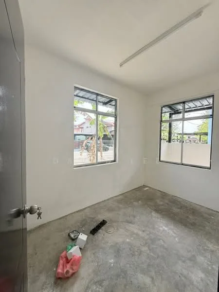 Room features: white painted walls, concrete flooring, two windows, metal roof, ceiling light fixture, door with handle, visible electrical outlets, unfurnished space.