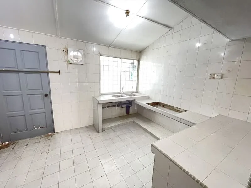 Kitchen features: white tiled walls, white tiled flooring, single-bowl stainless-steel sink, chrome faucet, window for natural light, grey cabinetry, countertop with cut-out for stove, exposed plumbing, ceiling light fixture.