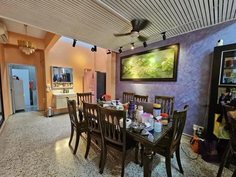 Dining features: large wooden dining table, 8 wooden dining chairs, pendant light fixture, 5-blade ceiling fan, decorative wall art, purple accent wall, speckled terrazzo flooring, open layout to kitchen, wall-mounted cabinet, kitchen area visible in background; style: modern. Kitchen features: stainless-steel fridge, white cabinetry, countertop with sink, kitchen island, open shelving, kitchen appliances visible; style: modern.