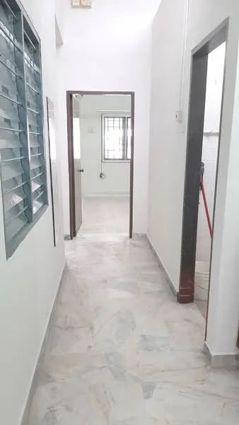 Room features: white painted walls, marble flooring, sliding window with metal grille, doorway leading to another room, doorway leading to bathroom, natural light from windows, neutral color scheme, clean and uncluttered space; style: modern.
