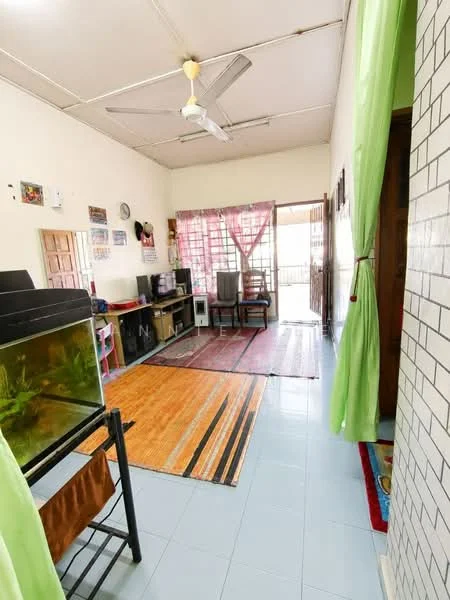 Room features: light blue tiled flooring, white painted walls, ceiling fan, wooden door, large window with sheer green curtains, area rug with geometric pattern, wooden furniture, fish tank, TV console, multiple rugs, open layout, natural light; style: minimalist.