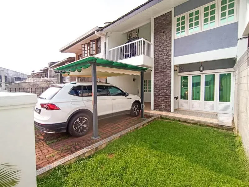 Exterior type: semi-detached house; features: car porch with awning, brick paved driveway, manicured lawn, green awning, stone cladding on facade, white painted facade, multiple windows, balcony with railing, air conditioning unit visible; style: modern.
