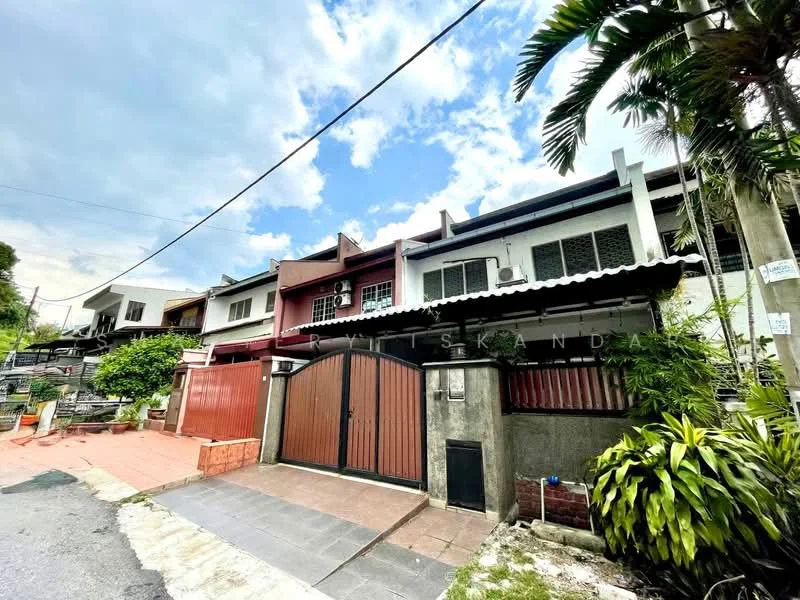 Exterior type: linked terrace house; features: red painted facade, white painted facade, gated entrance with double doors, paved driveway, manicured landscaping, tropical plants, front porch area, two-storey structure, visible air conditioning units, street view with overhead power lines; style: modern.