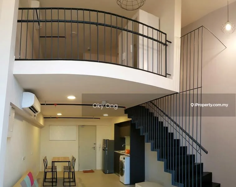 Room features: open-plan layout, black metal staircase, white painted walls, recessed downlights, wall-mounted air conditioning unit, dining table for two, kitchen area with appliances, metal railing on balcony, pendant light fixture, flooring not visible; style: modern.