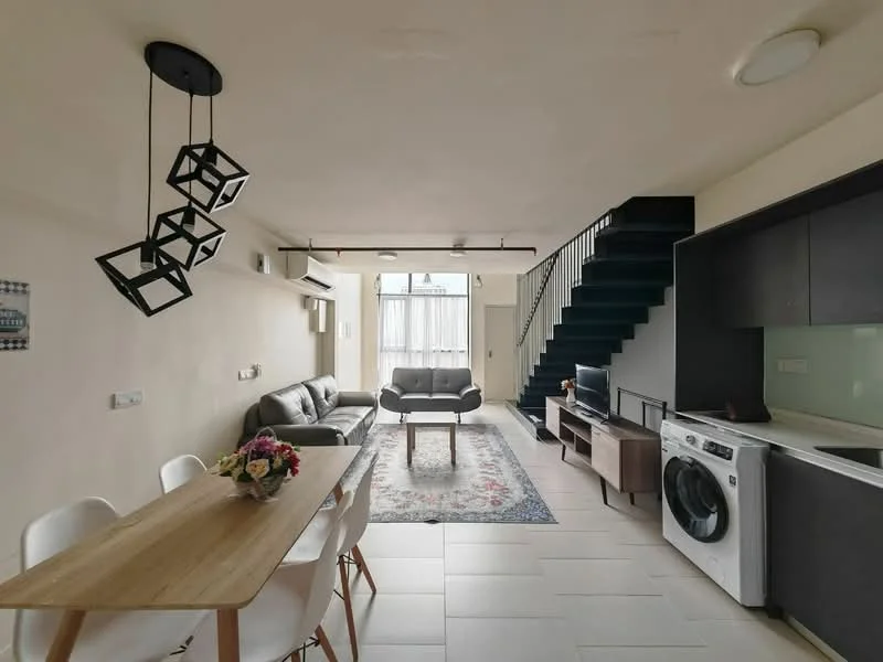 Living features: grey fabric sofa, wooden coffee table, area rug with floral pattern, wall-mounted TV, TV console, 5-blade ceiling fan, floor-to-ceiling windows, white painted walls, recessed downlights, open-plan layout, decorative wall art, plant in ceramic pot; style: modern. Dining features: 6-seater wooden dining table, white plastic dining chairs, hanging geometric pendant light; style: modern. Kitchen features: stainless-steel washing machine, built-in kitchen cabinetry, white countertop, open shelving, recessed downlights; style: modern. Staircase features: metal staircase with dark blue steps; style: modern.