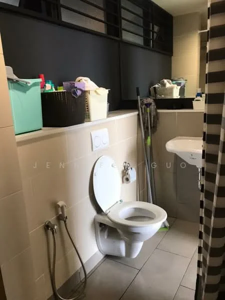 Bathroom features: white toilet, single-sink vanity with wall-mounted faucet, mirror above sink, grey tiled flooring, cream tiled walls, shower curtain, cleaning supplies in baskets, squeegee, storage baskets, wall-mounted shelves; style: modern.