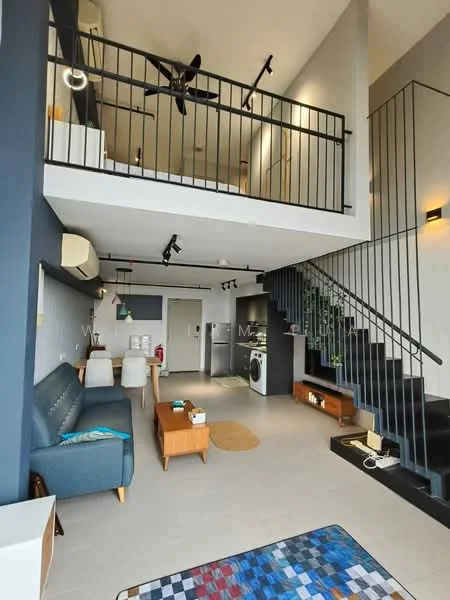 Living features: 3-seater fabric sofa in blue, wooden coffee table, area rug with geometric pattern, ceiling fan with integrated light, wall-mounted TV, staircase with black railing, open-plan layout, white walls with grey accent wall, tile flooring, decorative plants, wall-mounted air conditioning unit; style: modern. Kitchen features: stainless-steel fridge, built-in oven, freestanding washing machine, kitchen cabinetry, countertop with bar seating, open shelving, tile backsplash; style: modern.