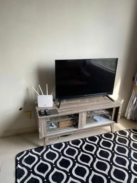 Living features: black flat-screen TV, wooden TV console with glass doors, decorative items on console, remote control, white router, black and white area rug with geometric pattern, cream painted walls, large window with sheer curtains, tile flooring; style: modern.