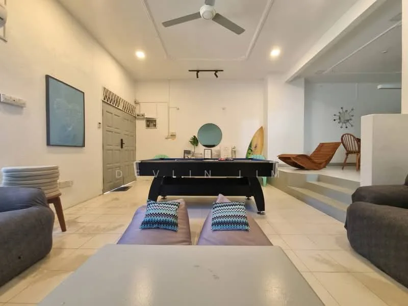 Living features: white painted walls, tile flooring, 5-blade ceiling fan, sofa in grey, coffee table, pool table, decorative cushions, wooden lounge chairs, wall-mounted artwork, round mirror, surfboard, step-up seating area; style: modern.