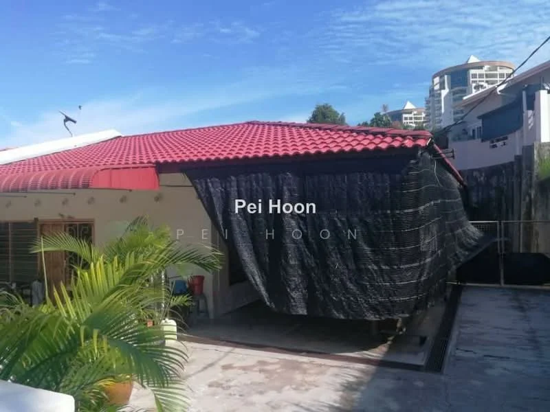 Exterior features: red pitched tile roof, black fabric covering, paved flooring, potted palm plant, surrounding greenery, fenced area.