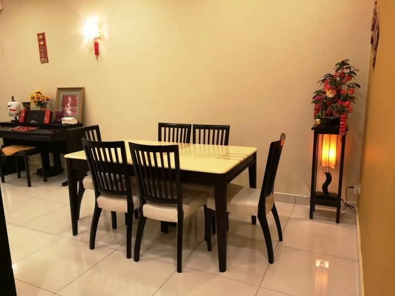 Dining features: 6-seater dining table with cream tabletop, black wooden dining chairs with beige cushions, white tiled flooring, yellow painted walls, decorative wall art, table lamp with wooden base, potted plant on side table, framed artwork on wall; style: modern.