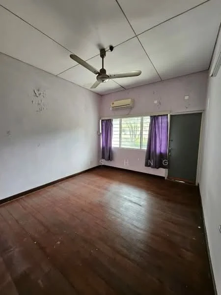 Room features: light purple painted walls, wooden flooring, 5-blade ceiling fan, wall-mounted split AC, window with white blinds, curtains in dark purple, door with glass panel, visible signs of wear on walls.