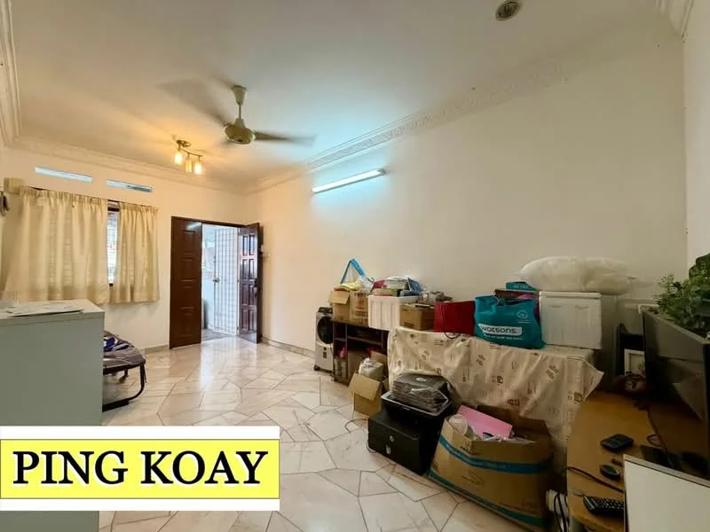 Room features: white painted walls, marble flooring, ceiling fan, window with sheer curtains, wooden door, boxes and storage items, television, decorative plants.